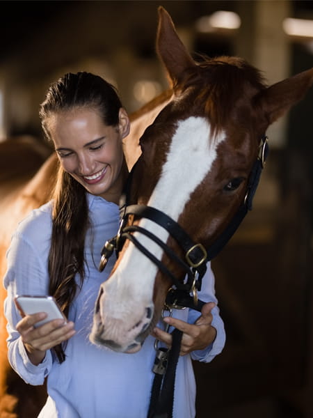 Woman with horse on her phone