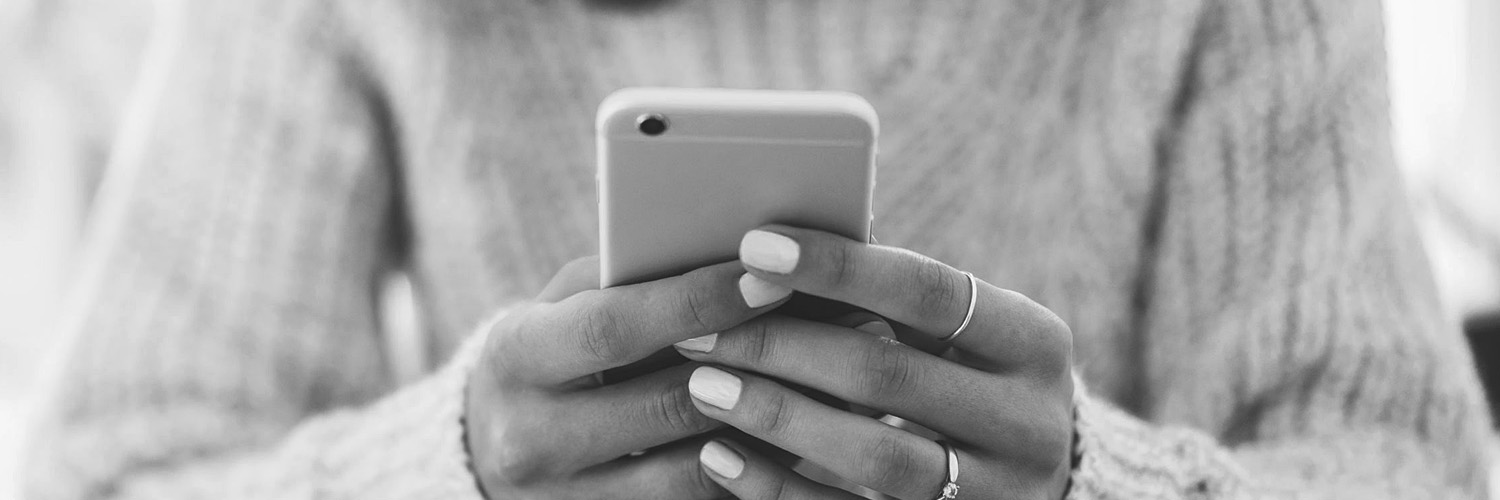 Woman's hands holding a phone and texting